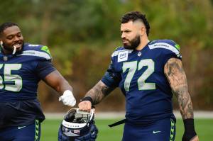 Seahawks tackle Abe Lucas (72) fist bumps fellow tackle Michael Jerrell (65) during practice at the Virginia Mason Athletic Center practice in Renton on Wednesday, Oct. 23 (Photo courtesy of Edwin Hooper / Seattle Seahawks)