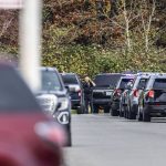 Law enforcement vehicles line the road leading to Marysville Pilchuck High School on Friday, Oct. 25, 2024 in Marysville, Washington. (Olivia Vanni / The Herald)