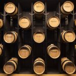 Small wooden casks line a wall at the new Heritage Distillery tasting room at Angel of the Winds Casino on Friday, Oct. 25, 2024 in Arlington, Washington. (Olivia Vanni / The Herald)