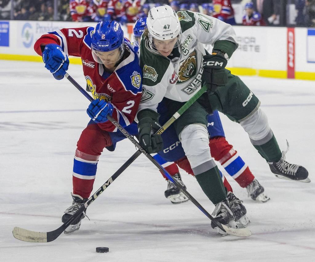 Silvertips Kaden Hammell fights with an Edmonton player for the puck during the game against the Edmonton Oil Kings on Friday, Oct. 25, 2024 in Everett, Washington. (Olivia Vanni / The Herald)