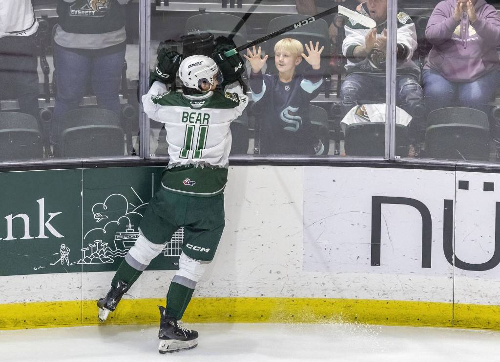 Silvertips’ Carter Bear celebrates with a fan after scoring during the game against the Edmonton Oil Kings on Friday, Oct. 25, 2024 in Everett, Washington. (Olivia Vanni / The Herald)
