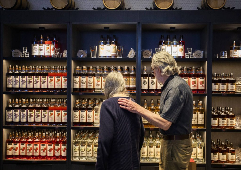 People browse the large selection of alcohol available for purchase at the new Heritage Distillery tasting room at Angel of the Winds Casino on Friday, Oct. 25, 2024 in Arlington, Washington. (Olivia Vanni / The Herald)