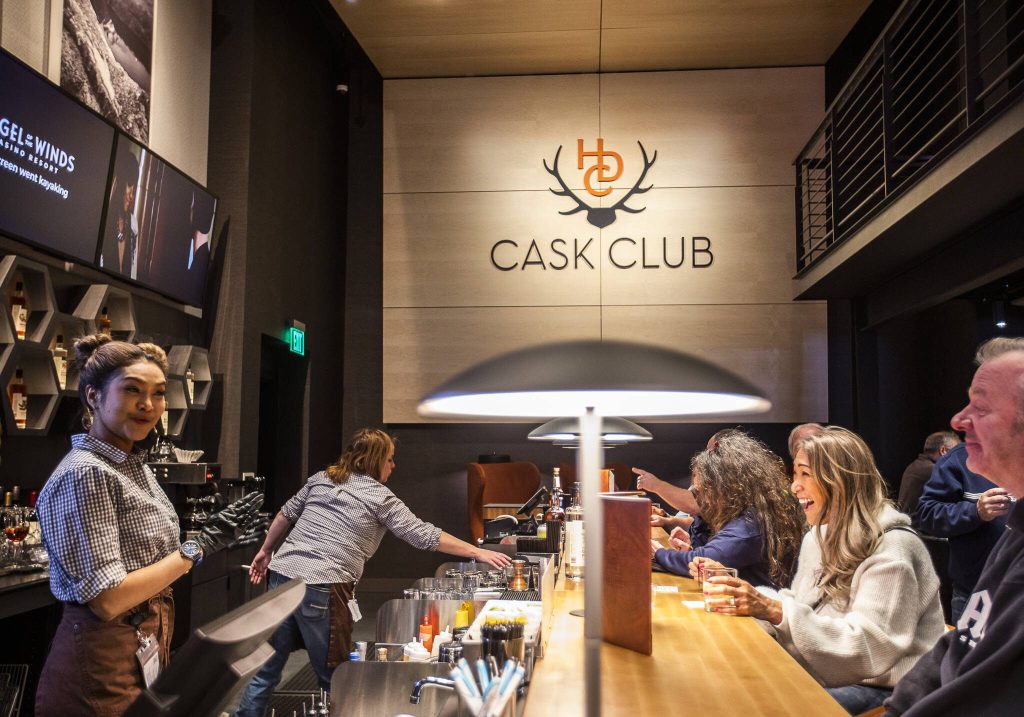 People enjoy drinks at the bar at the new Heritage Distillery tasting room at Angel of the Winds Casino on Friday, Oct. 25, 2024 in Arlington, Washington. (Olivia Vanni / The Herald)
