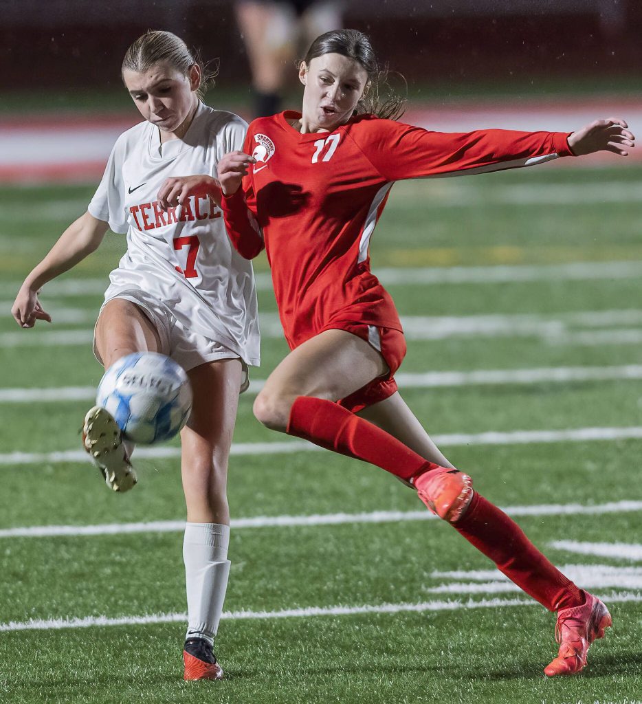 Stanwoods Kyler Burke tries to cut off Mountlake Terraces Katie Woodman as she kicks the ball during the 3A district game on Thursday, Oct. 31, 2024 in Stanwood, Washington. (Olivia Vanni / The Herald)