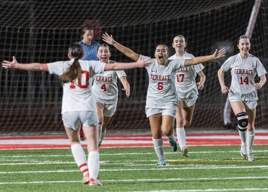 Mountlake Terrace players run toward each other to celebrate after scoring a goal during the 3A district game against Stanwood on Thursday, Oct. 31, 2024 in Stanwood, Washington. (Olivia Vanni / The Herald)