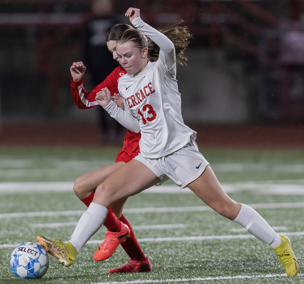 Mountlake Terraces Daphne Ostberg steals the ball away from Stanwoods Kyler Burke during the 3A district game on Thursday, Oct. 31, 2024 in Stanwood, Washington. (Olivia Vanni / The Herald)