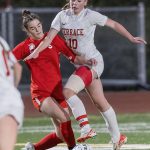 Mountlake Terraces Ally Villalobos-VanSlooten leaps in the air while Stanwoods Kendall Rhodes tries to knock the ball away during the 3A district game on Thursday, Oct. 31, 2024 in Stanwood, Washington. (Olivia Vanni / The Herald)