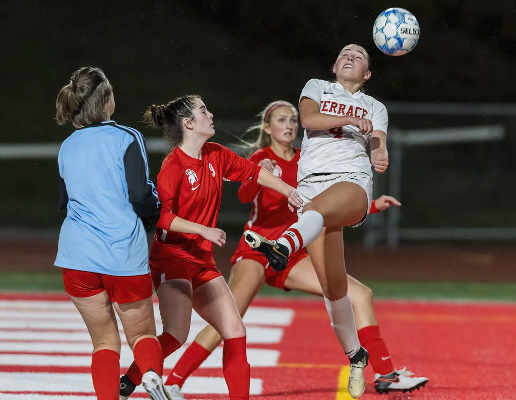 Mountlake Terraces Claire August leaps in the air to head the ball during the 3A district game against Stanwood on Thursday, Oct. 31, 2024 in Stanwood, Washington. (Olivia Vanni / The Herald)