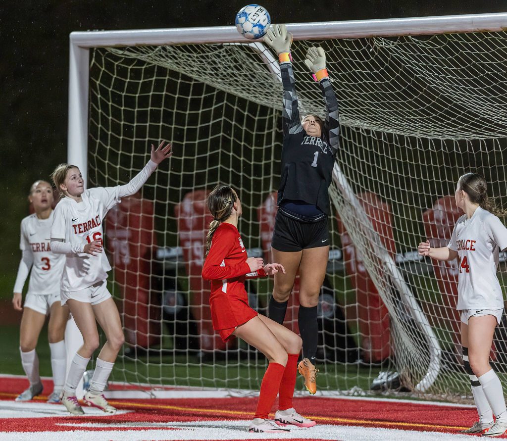 Mountlake Terraces Jordyn Stokes tips a shot over the top of the net during the 3A district game against Stanwood on Thursday, Oct. 31, 2024 in Stanwood, Washington. (Olivia Vanni / The Herald)