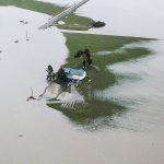 A house is completely surrounded by floodwater along Pioneer Highway on Wednesday, Dec. 6, 2023 in Stanwood, Washington. (Olivia Vanni / The Herald)