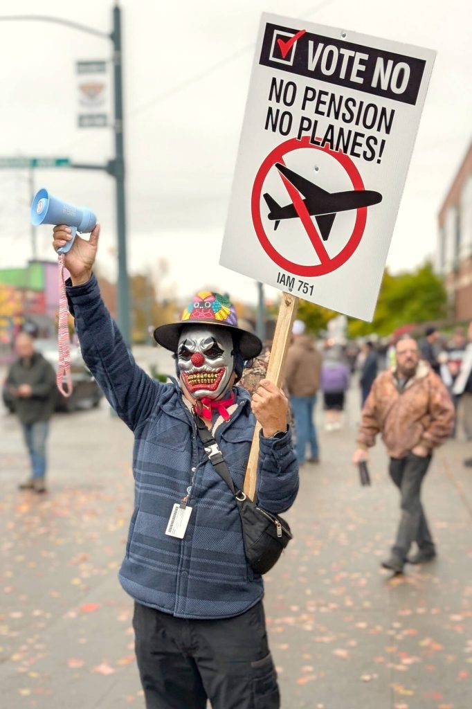 A man, who only gave first name as Eugenio, demonstrates outside of the Angel of the Winds Arena with a handheld siren and a vote no sign on Monday, Nov. 4, 2024, in Everett, Washington. (Michael Henneke / The Herald)