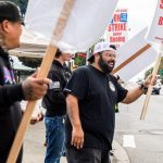 Matt Saldivar, a lead mechanic at Boeing for 5 years, smiles while picketing with other Boeing workers on strike on Monday, Sept. 16, 2024 in Everett, Washington. (Olivia Vanni / The Herald)