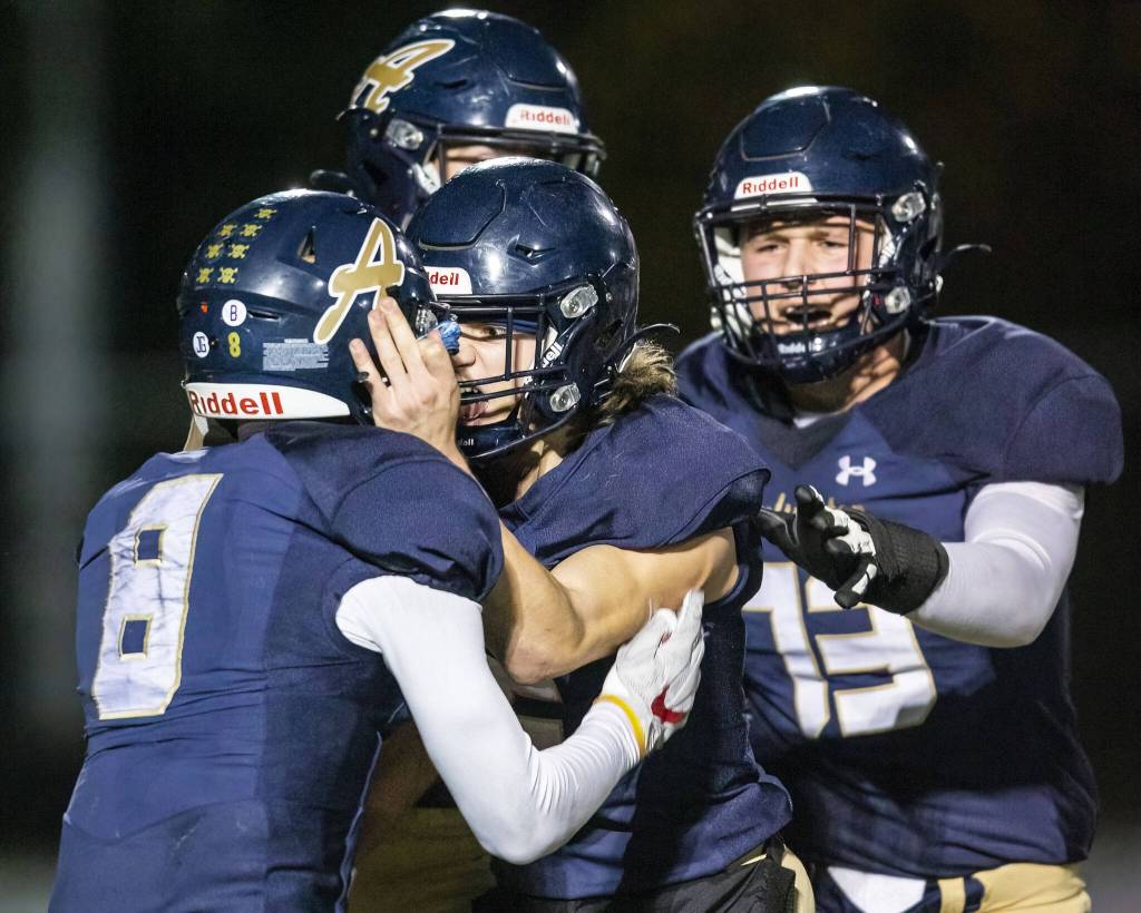 Arlington players celebrate Kaid Hunters touchdown during the game against Lake Stevens on Friday, Nov. 1, 2024 in Arlington, Washington. (Olivia Vanni / The Herald)