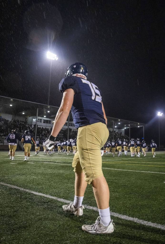 Arlingtons Dylan Scott runs back toward the sidelines after warming up at halftime during the game against Lake Stevens on Friday, Nov. 1, 2024 in Arlington, Washington. (Olivia Vanni / The Herald)