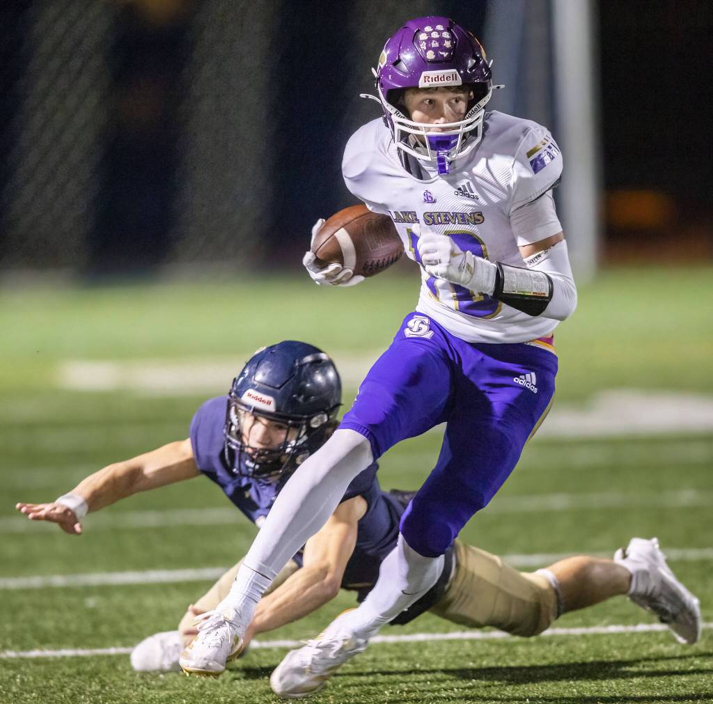 Lake Stevens Cody Lynch escapes a tackle while running the ball during the game against Arlington on Friday, Nov. 1, 2024 in Arlington, Washington. (Olivia Vanni / The Herald)