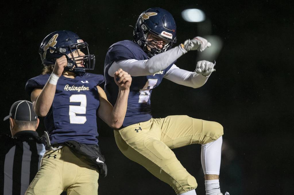 Arlingtons Kaid Hunter and Chase Deberry celebrate Hunters touchdown during the game against Lake Stevens on Friday, Nov. 1, 2024 in Arlington, Washington. (Olivia Vanni / The Herald)