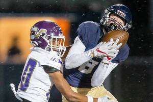 Arlington’s Kaid Hunter makes a catch and runs into the end zone for a touchdown during the game against Lake Stevens on Friday, Nov. 1, 2024 in Arlington, Washington. (Olivia Vanni / The Herald)