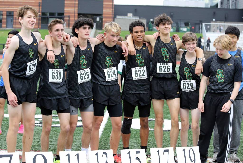 Members of the Shorecrest High School boys cross country team pose for a photo at the District 1/2 Cross Country Championships at Lakewood High School in Arlington, Wash., on Nov. 2, 2024. The Scots finished third in 3A. (Taras McCurdie / The Herald)