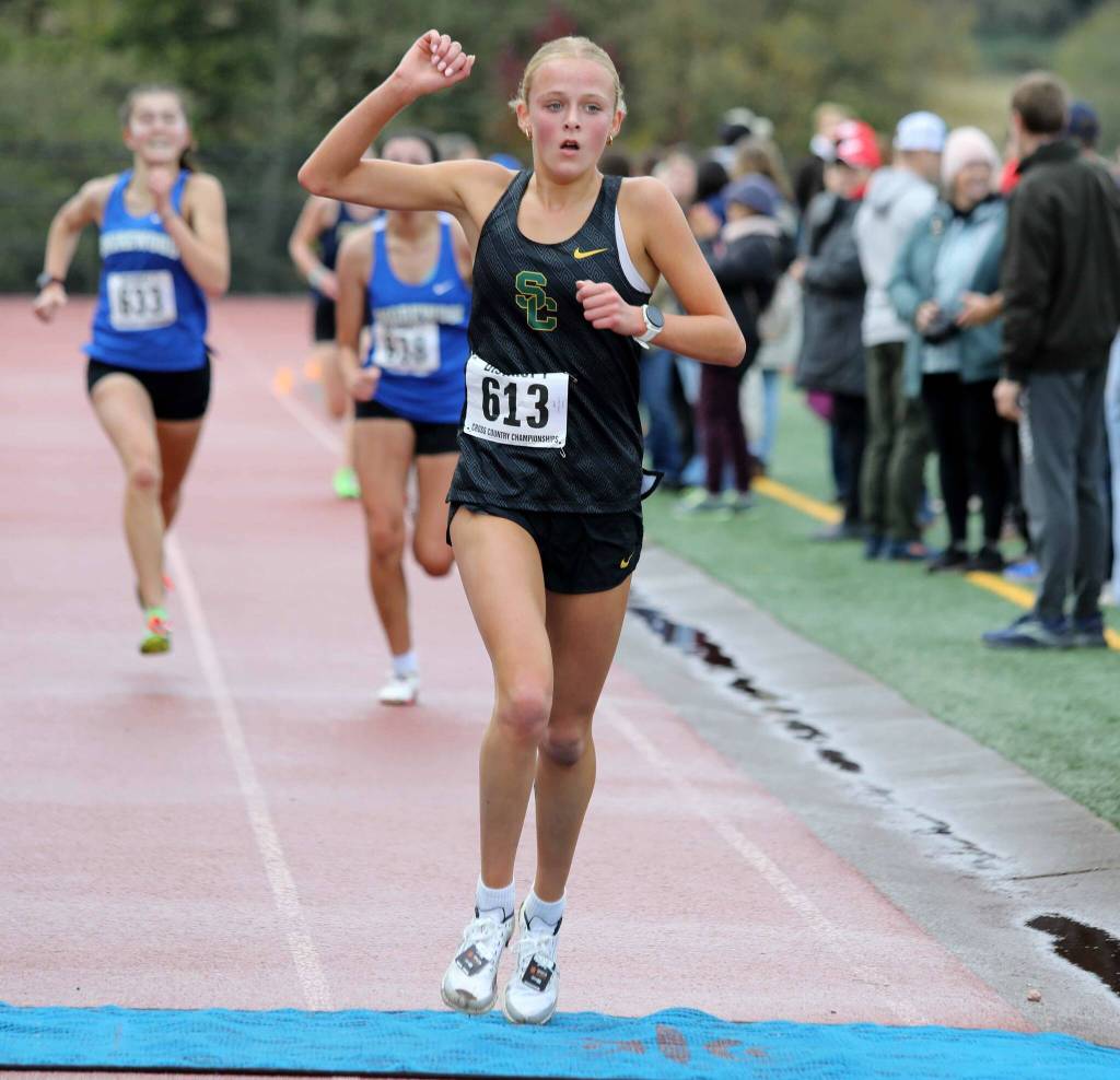 Shorecrest freshman Harper Birgfeld crosses the finish line during the District 1/2 Cross Country Championships at Lakewood High School in Arlington, Wash., on Nov. 2, 2024. Birgfeld finished second in the 3A girls race. (Taras McCurdie / The Herald)