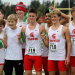 Members of the Stanwood High School boys cross country team pose for a photo at the District 1/2 Cross Country Championships at Lakewood High School in Arlington, Wash., on Nov. 2, 2024. The Spartans finished fourth in 3A. (Taras McCurdie / The Herald)