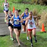 Stanwood junior Brooke Berry (far right) trots ahead a group of runners during the District 1/2 Cross Country Championships at Lakewood High School in Arlington, Wash., on Nov. 2, 2024. (Taras McCurdie / The Herald)