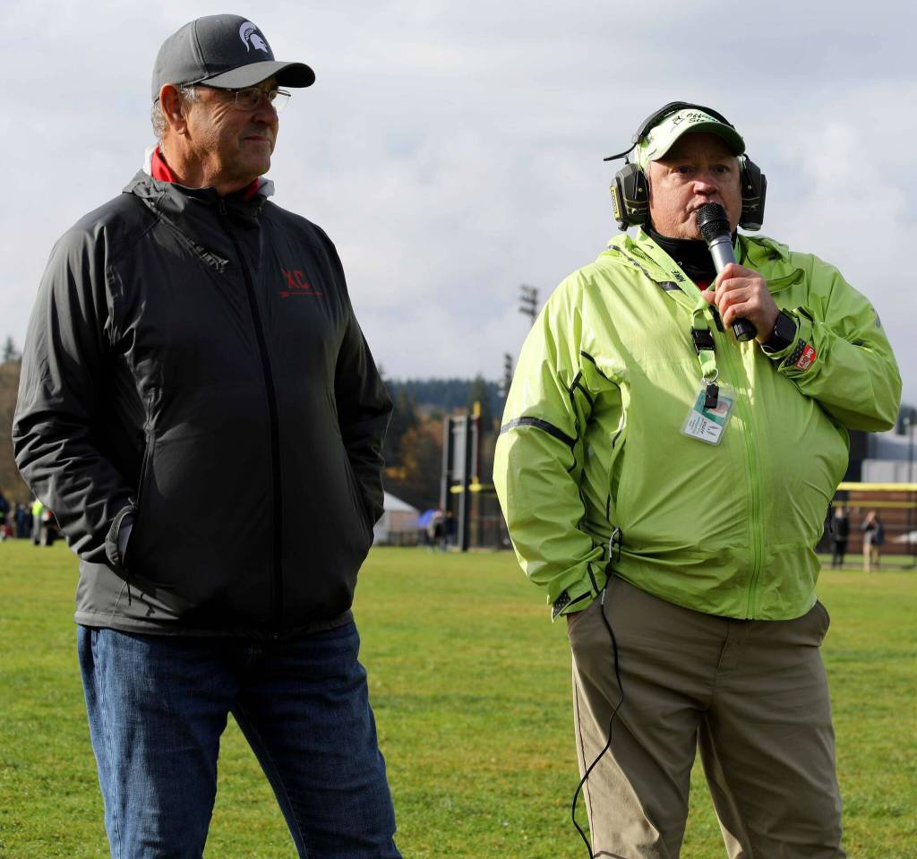 Stanwood coach Mike Evans is announced before the 2024 District 1/2 Cross Country 3A girls race at Lakewood High School in Arlington, Wash., on Nov. 2, 2024. Evans is retiring after this season and was the founder of the Hole in the Wall meet. (Taras McCurdie / The Herald)