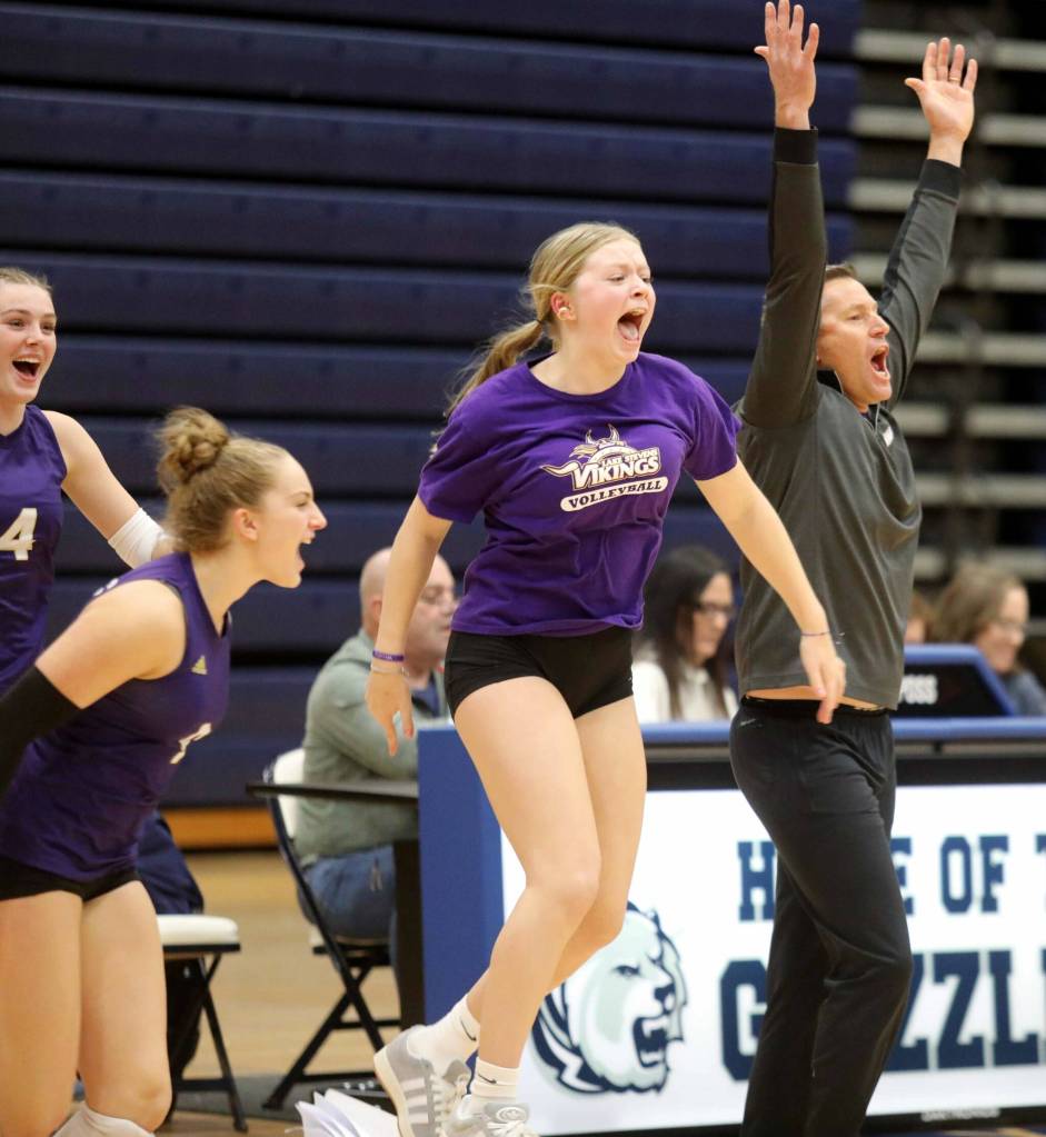 Lake Stevens coach Kyle Hoglund and his team celebrate after scoring the final point in the Wesco 4A title game against Glacier Peak in Snohomish, Wash., on Monday, Nov. 4, 2024. The Vikings won in four sets, 3-1.