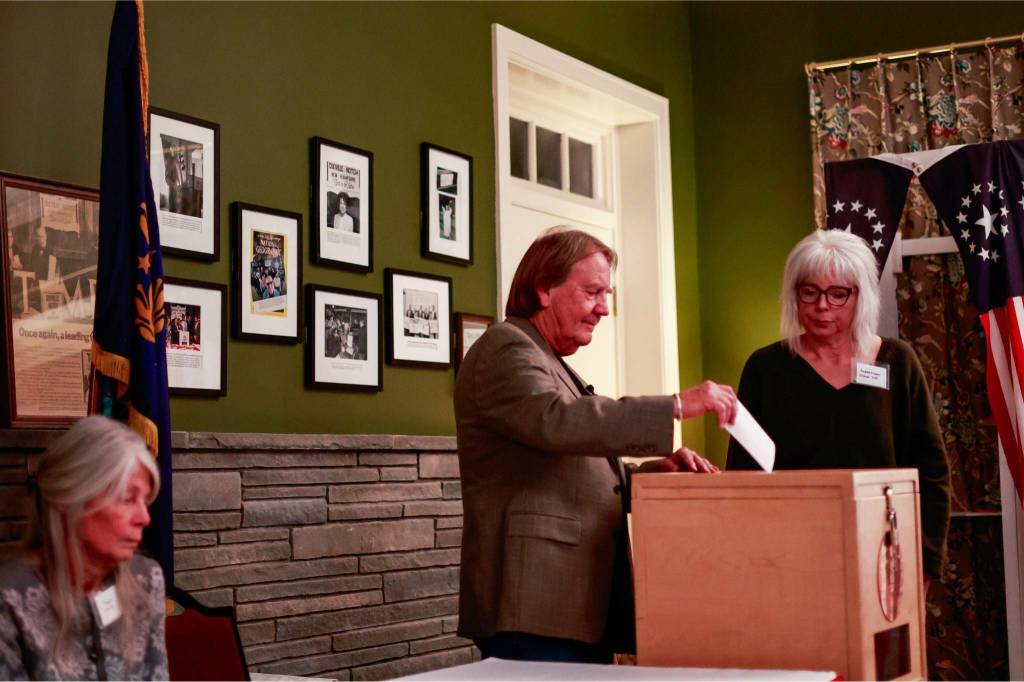 Ballots are cast in Dixville Notch, N.H. the tiny town that traditionally holds a first-in-the-nation vote, just after midnight on Tuesday. At least in Dixville Notch, the general election ended in a tie: three votes for Kamala Harris, and three for Donald Trump. Center, Tom Tillotson; right, Valarie Maxwell. (Ryan David Brown / The New York Times)