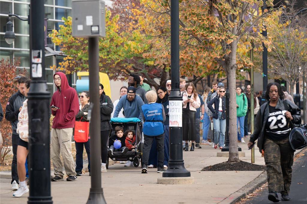 Voters in line for a polling place at the Community College of Philadelphia on Tuesday. Democrats say initial signs indicated turnout in the city is strong. (Jessica Griffin / The Philadelphia Inquirer)