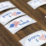 I Voted stickers cover a table at the entrance to the Snohomish County Auditors Office on Tuesday, Nov. 5, 2024 in Everett, Washington. (Olivia Vanni / The Herald)