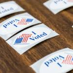“I Voted” stickers cover a table at the entrance to the Snohomish County Auditor’s Office on Tuesday, Nov. 5, 2024 in Everett, Washington. (Olivia Vanni / The Herald)