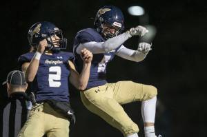 Arlington’s Kaid Hunter and Chase Deberry celebrate Hunter’s touchdown during the game against Lake Stevens on Friday, Nov. 1, 2024 in Arlington, Washington. (Olivia Vanni / The Herald)
