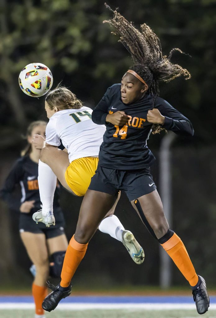 Shorecrests Olivia Taylor and Monroes Halle Keller both leap in the air to head the ball during the 3A district game on Thursday, Nov. 7, 2024 in Shoreline, Washington. (Olivia Vanni / The Herald)