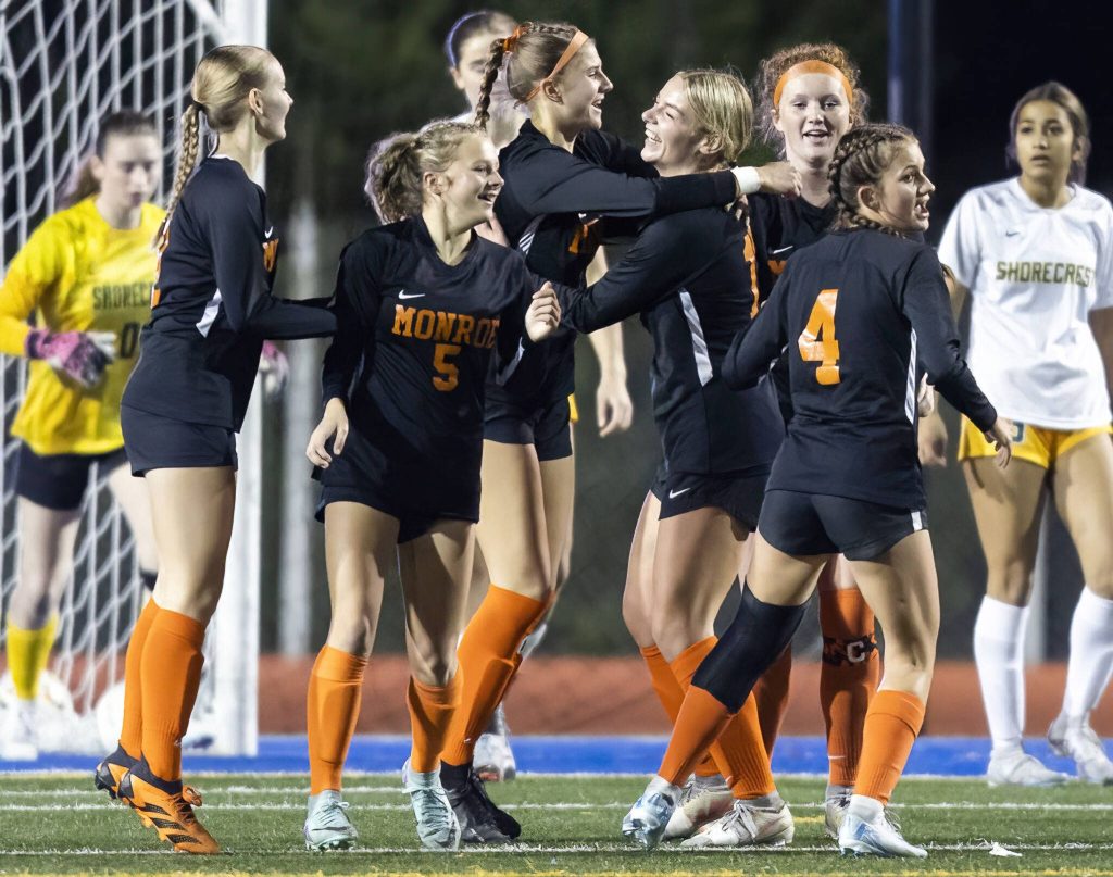 Monroes Kinsey Mann, right, is hugged by teammate Sydney Garner, left, after scoring during the 3A district game against Shorecrest on Thursday, Nov. 7, 2024 in Shoreline, Washington. (Olivia Vanni / The Herald)