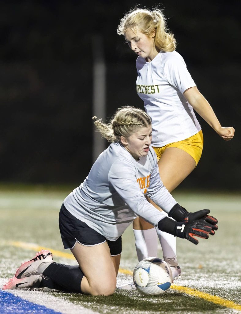 Shorecrests Sarah Ehrhart collides with Monroes goalie Brooklyn Krache during the 3A district game on Thursday, Nov. 7, 2024 in Shoreline, Washington. (Olivia Vanni / The Herald)