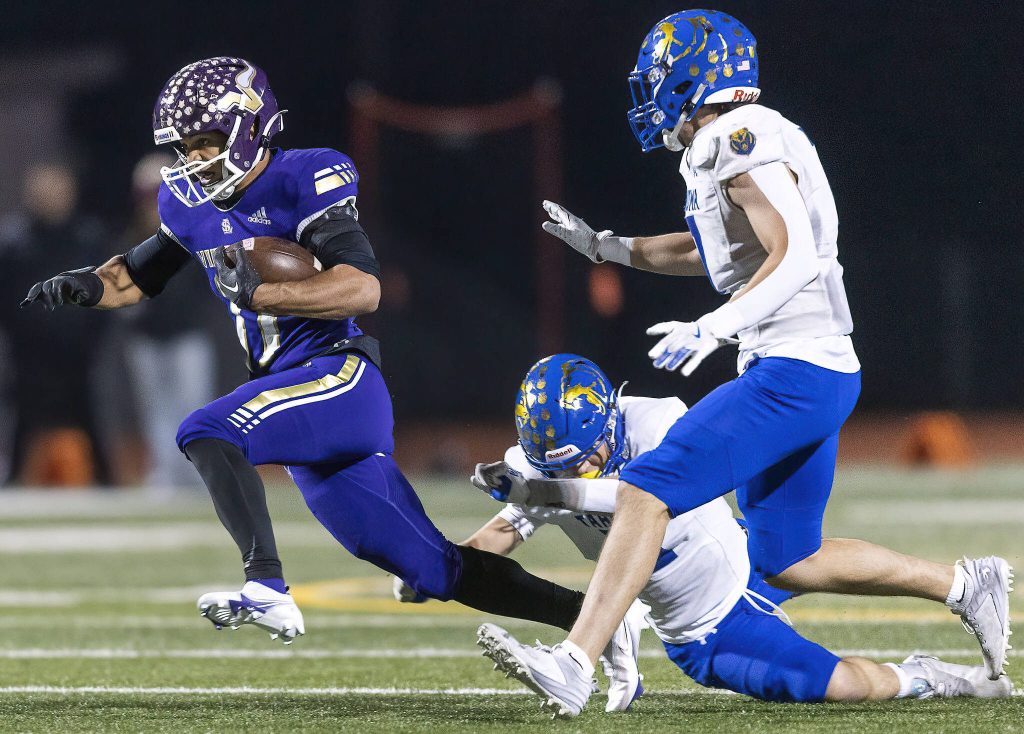 Lake Stevens Jayshon Limar escapes a tackle while running the ball during the 4A district game against Tahoma on Friday, Nov. 8, 2024 in Lake Stevens, Washington. (Olivia Vanni / The Herald)