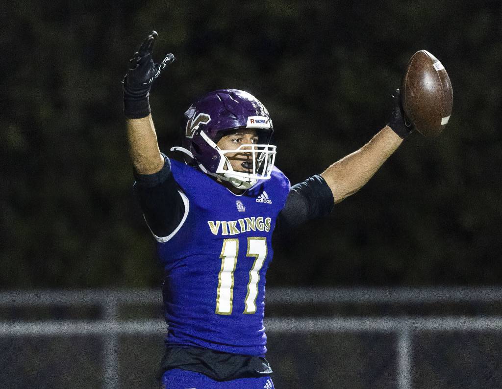 Lake Stevens Jayshon Limar puts his arms in the air in celebration after scoring a touchdown during the 4A district game against Tahoma on Friday, Nov. 8, 2024 in Lake Stevens, Washington. (Olivia Vanni / The Herald)