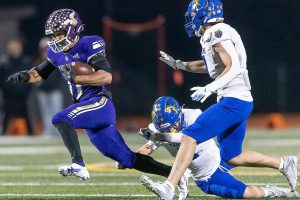 Lake Stevens’ Jayshon Limar escapes a tackle while running the ball during the 4A district game against Tahoma on Friday, Nov. 8, 2024 in Lake Stevens, Washington. (Olivia Vanni / The Herald)