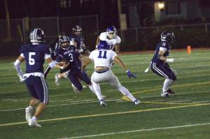 Glacier Peak quarterback Lucas Entler runs with the ball during a 28-0 loss to Curtis on Friday, Nov. 8, 2024. (Aaron Coe / The Herald)