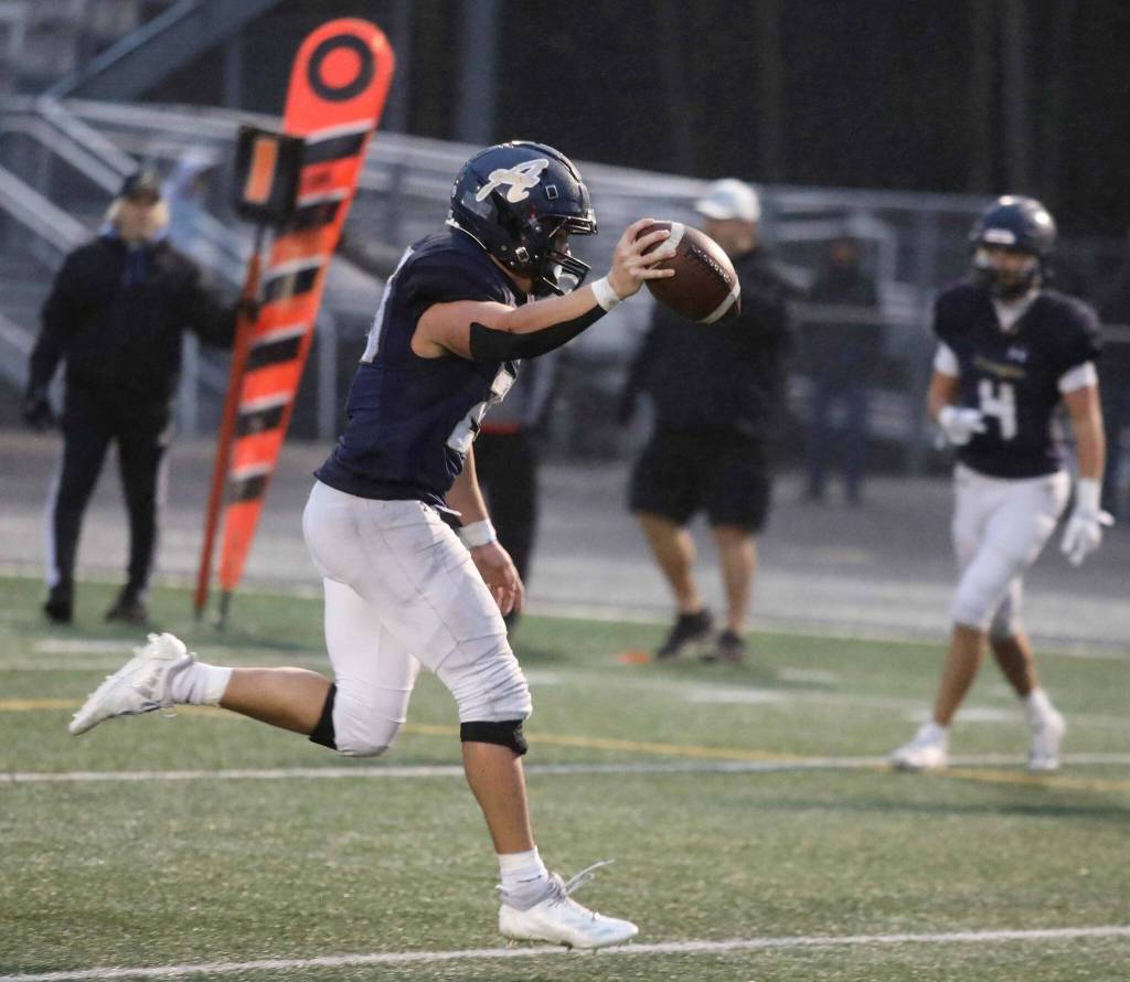 Arlington senior running back Caleb Reed runs one of his four touchdowns during a district winner-to-state, loser-out Round of 32 game at John C. Larson Stadium in Arlington, Wash., on Saturday, Nov. 9, 2024. The Eagles won 56-35. (Taras McCurdie / The Herald)