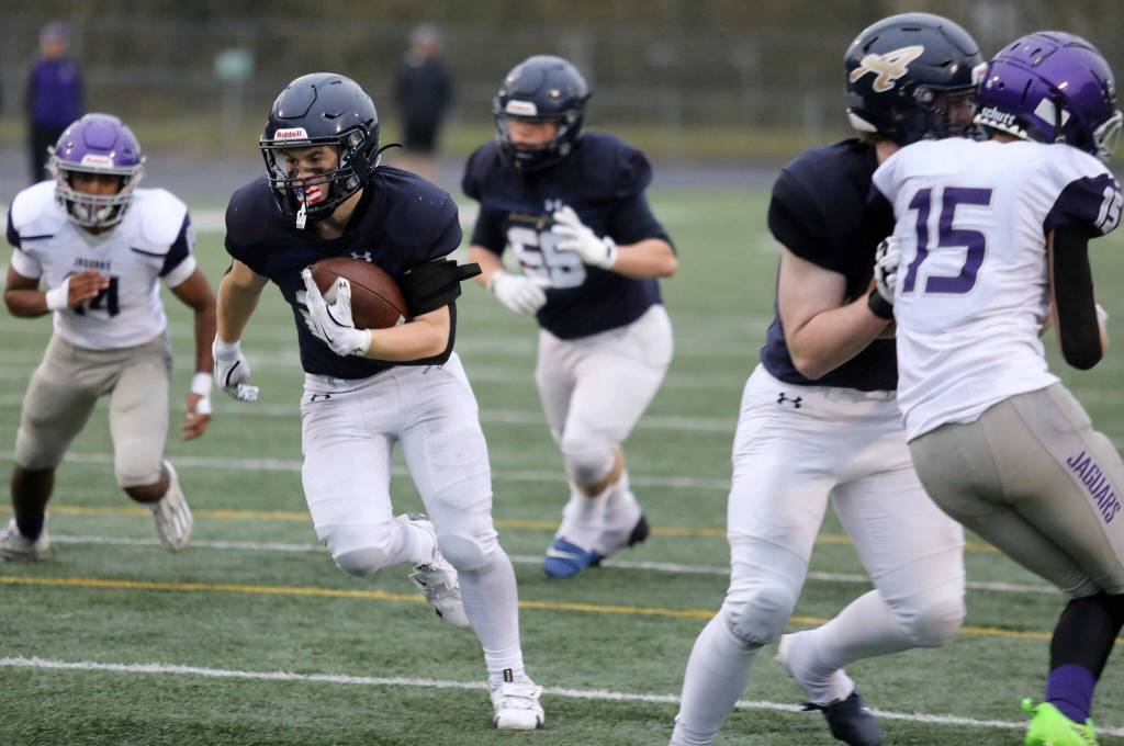 Arlington junior running back Jace Graham follows his blockers during a district winner-to-state, loser-out Round of 32 game at John C. Larson Stadium in Arlington, Wash., on Saturday, Nov. 9, 2024. The Eagles won 56-35. (Taras McCurdie / The Herald)