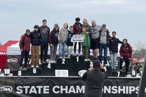 Cascade's Jacob Hopkins (top step) poses with coaches, teammates, family and friends after winning his third straight state title in the boys ambulatory race at Sun Willows Golf Course on Saturday, Nov. 9, 2024. (Photo courtesy of Steve Bertrand)