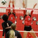 Stanwood junior setter Addison Bowie (No. 5) and junior middle blocker Presley Harris (No. 9) attempt to block Monroe sophomore Shannara Peebles hit during a District 1 3A quarterfinals match in Stanwood, Wash., on Tuesday, Nov. 12, 2024. The Spartans won 3-1. (Taras McCurdie / The Herald)