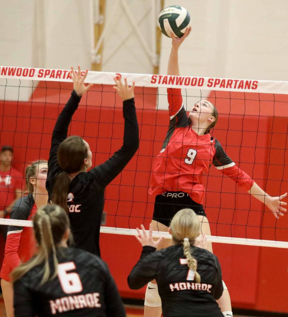 Stanwood junior middle blocker Presley Harris tips the ball during a District 1 3A quarterfinals match against Monroe in Stanwood, Wash., on Tuesday, Nov. 12, 2024. The Spartans won 3-1. (Taras McCurdie / The Herald)