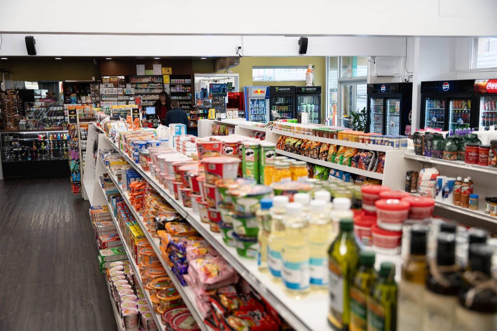Lia Tetreault serves a sole customer inside the Soundview Deli on Monday, Nov. 18, 2024, in Everett, Washington. (Will Geschke / The Herald)