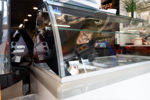 Lia Tetreault serves strawberry ice cream to a customer on Monday, Nov. 18 at the Soundview Deli in Everett, Washington. (Will Geschke/The Herald)