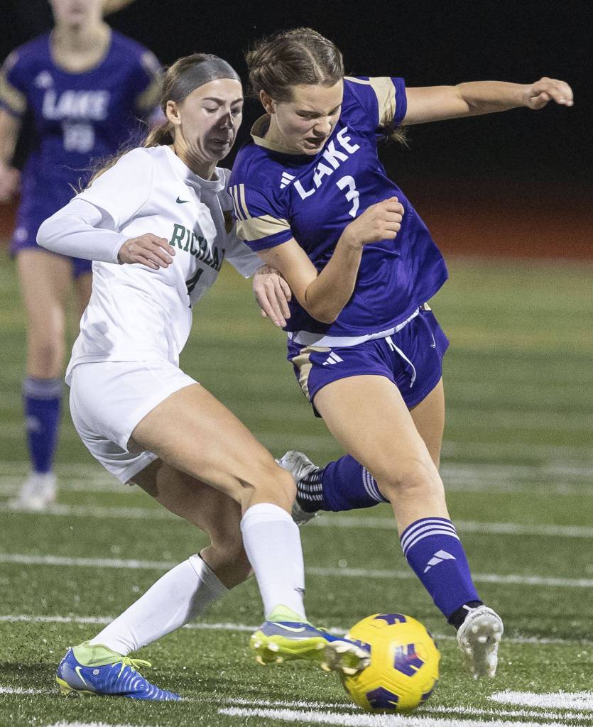 Lake Stevens Cora Jones is pushed off the ball while dribbling during the 4A state playoff game against Richland on Wednesday, Nov. 13, 2024 in Lake Stevens, Washington. (Olivia Vanni / The Herald)