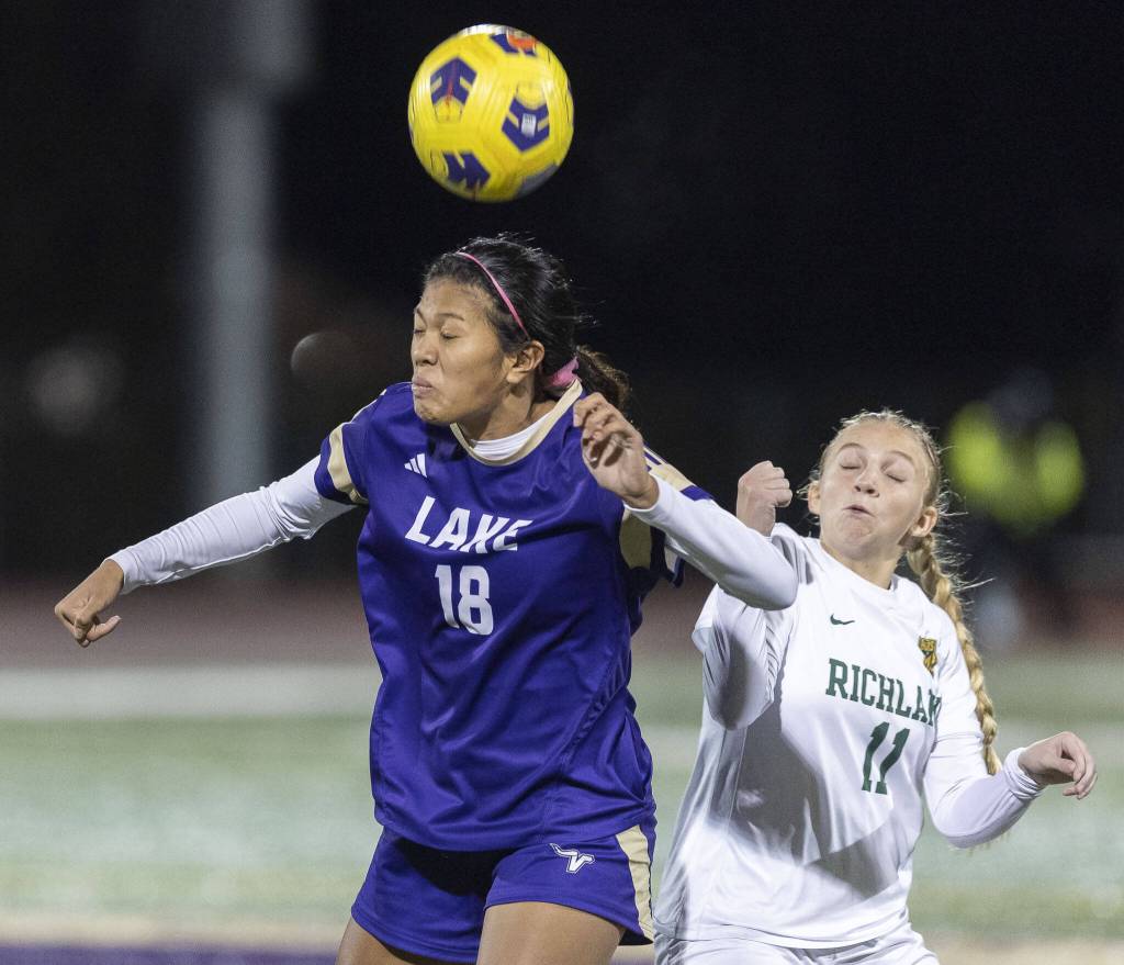 Lake Stevens Noelani Tupua leaps in the air to head the ball during the 4A state playoff game against Richland on Wednesday, Nov. 13, 2024 in Lake Stevens, Washington. (Olivia Vanni / The Herald)