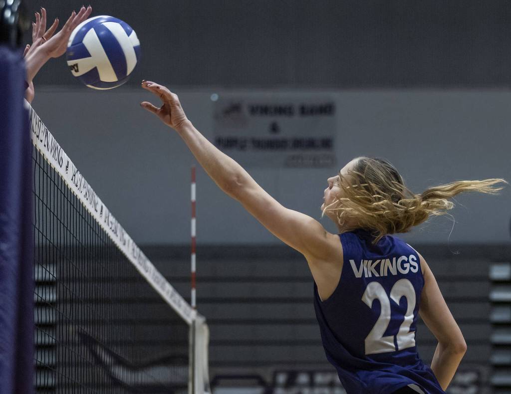 Lake Stevens Laura Eichert tries to tip the ball over the net during the 4A district semifinal game on Thursday, Nov. 14, 2024 in Lynnwood, Washington. (Olivia Vanni / The Herald)