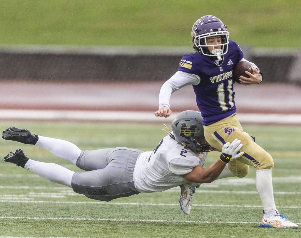 Lake Stevens Cannon Kennard is tackled by Meads Max Faagau during the 4A state playoff game on Saturday, Nov. 16, 2024 in Lake Stevens, Washington. (Olivia Vanni / The Herald)